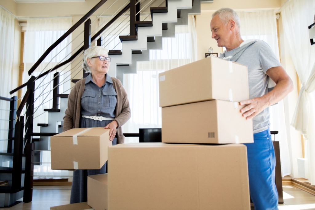 downsizing seniors stacking moving boxes 1024x683